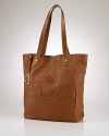 Crafted for chic versatility in sumptuous pebbled leather, the Putnum tote is finished with equestrian-inspired accents and an elegantly embossed crown crest for an iconic heritage look. From Lauren Ralph Lauren.