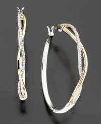 Beautiful classic diamond hoops with a twist. These diamond earrings feature sparkling round-cut diamonds (1/5 ct. t.w.) set in 14k gold and sterling silver. Approximate diameter: 1-1/8 inches. Beautiful classic diamond hoops with a twist. These diamond earrings feature sparkling round-cut diamonds (1/5 ct. t.w.) set in 14k gold and sterling silver. Approximate diameter: 1-1/8 inches.