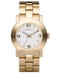 Go for all that glitters. This ultra-cool Marc by Marc Jacobs watch features a goldtone ion-plated stainless steel bracelet and round case. Logo etched at bezel. White dial with logo, goldtone numerals and crystal accents at markers. Quartz movement. Water resistant to 30 meters. Two-year limited warranty. Go for all that glitters. This ultra-cool Marc by Marc Jacobs watch features a goldtone ion-plated stainless steel bracelet and round case. Logo etched at bezel. White dial with logo, goldtone numerals and crystal accents at markers. Quartz movement. Water resistant to 30 meters. Two-year limited warranty.