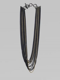 An edgy piece with a beautiful drape in 18k gold and blackened sterling silver box link chains. 18K goldBlackened sterling silverLength, about 18Toggle closureImported 