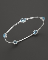 Blue topaz stations sparkle on this textured sterling silver bangle from Ippolita. Blue topaz stations sparkle on this textured sterling silver bangle from Ippolita.
