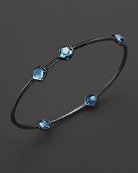 A modern sterling silver bangle with blue topaz stations from Ippolita. A modern sterling silver bangle with blue topaz stations from Ippolita.