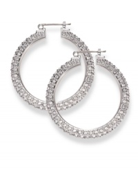 Often casually chic in nature, traditional hoop earrings get a glamorous upgrade courtesy of Swarovski. Embellished with dazzling crystals throughout, they're set in silver tone mixed metal. Approximate diameter: 1-9/16 inches. Often casually chic in nature, traditional hoop earrings get a glamorous upgrade courtesy of Swarovski. Embellished with dazzling crystals throughout, they're set in silver tone mixed metal. Approximate diameter: 1-9/16 inches.