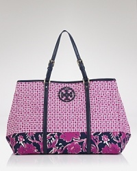 A leather logo details this spacious Tory Burch handbag, styled for practicality in nylon. A simple snap closure secures the top, and the tote opens to a lined interior with 3 pockets. A leather logo details this spacious Tory Burch handbag, styled for practicality in nylon. A simple snap closure secures the top, and the tote opens to a lined interior with 3 pockets.