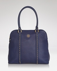 Studded details lend a subtle edge to this very poised Tory Burch tote, styled in leather. With pointed toe pumps and a pencil skirt the look's Park Avenue polished. Studded details lend a subtle edge to this very poised Tory Burch tote, styled in leather. With pointed toe pumps and a pencil skirt the look's Park Avenue polished.