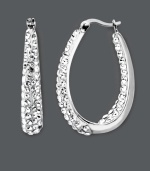 Celebrity-inspired style that will have you looking red-carpet ready. These glamorous Kaleidoscope hoop earrings feature a sparkling in and out design accentuated by clear crystals with Swarovski Elements. Crafted in sterling silver. Approximate diameter: 1-1/10 inches.