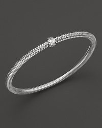 A single diamond station shines on this modern 18K white gold mesh bangle from Roberto Coin. A single diamond station shines on this modern 18K white gold mesh bangle from Roberto Coin.