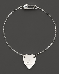 From the Trademark Collection, this sweet sterling silver bracelet features a woven chain with engraved logo heart charm. Designed by Gucci. From the Trademark Collection, this sweet sterling silver bracelet features a woven chain with engraved logo heart charm. Designed by Gucci.