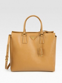 Saffiano leather in a roomy top-handle carryall with metal logo detail.Double top handles, 5 dropAdjustable detachable shoulder strap, 15-17 dropProtective metal feetTwo inside zip pocketsThree inside open pocketsPrada logo lining12¾W X 12H X 4½DMade in Italy Saffiano leather in a roomy top-handle carryall with metal logo detail.Double top handles, 5 dropAdjustable detachable shoulder strap, 15-17 dropProtective metal feetTwo inside zip pocketsThree inside open pocketsPrada logo lining12¾W X 12H X 4½DMade in Italy