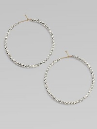 Hoops of 14k gold wire are set with faceted sterling silver beads that catch and reflect light with a warm radiance.14k yellow gold and sterling silverDiameter, about 1½Ear wireMade in USA Hoops of 14k gold wire are set with faceted sterling silver beads that catch and reflect light with a warm radiance.14k yellow gold and sterling silverDiameter, about 1½Ear wireMade in USA