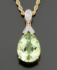 A jewel drop to enchant. This faceted green quartz (9 ct. t.w.) pendant is topped with sparkling bow-shaped diamond accents and finished in 14K gold. Approximate length: 18 inches. Approximate drop: 1-1/4 inches.