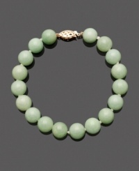 Green jade beads (10 mm) add a pale palette of color to your look. Pair this trendy beaded look with other stackable bracelets, or wear it alone for a subtle statement. Intricate clasp crafted in 14k gold. Approximate length: 7-1/2 inches. Green jade beads (10 mm) add a pale palette of color to your look. Pair this trendy beaded look with other stackable bracelets, or wear it alone for a subtle statement. Intricate clasp crafted in 14k gold. Approximate length: 7-1/2 inches.