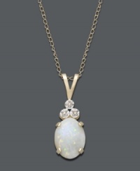 An iridescent sheen adds elegance to any look. Necklace features an oval-cut opal (9/10 ct. t.w.) accented by three, round-cut, diamond accents. Setting and chain crafted in 14k gold. Approximate length: 18 inches. Approximate drop: 3/4 inch. An iridescent sheen adds elegance to any look. Necklace features an oval-cut opal (9/10 ct. t.w.) accented by three, round-cut, diamond accents. Setting and chain crafted in 14k gold. Approximate length: 18 inches. Approximate drop: 3/4 inch.