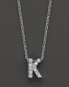 From the Tiny Treasures collection, a diamond K necklace. With signature ruby accent. Designed by Roberto Coin.