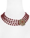 Four rows of richly hued stones form this elegant Carolee statement necklace, accented by an ornate floral closure.