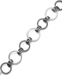Elevate your ensemble with simple accessories. This trendy bracelet by Alfani features a playful interlocking circle design crafted in silver tone and hematite tone mixed metal. Approximate length: 7-3/4 inches. Elevate your ensemble with simple accessories. This trendy bracelet by Alfani features a playful interlocking circle design crafted in silver tone and hematite tone mixed metal. Approximate length: 7-3/4 inches.