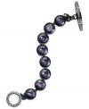 Purple reigns. This toggle bracelet from Juicy Couture showcases round glass stones in purple hues. Finished with a toggle closure embellished with pave accents. Crafted in silver tone mixed metal. Approximate length: 7-1/2 inches.