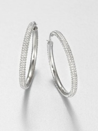 From the Brilliance Collection. The design is simple but the look is shimmering in these slender hoops set with rows of dazzling rhinestones.GlassSilvertoneDiameter, about 1.25PiercedImported From the Brilliance Collection. The design is simple but the look is shimmering in these slender hoops set with rows of dazzling rhinestones.GlassSilvertoneDiameter, about 1.25PiercedImported