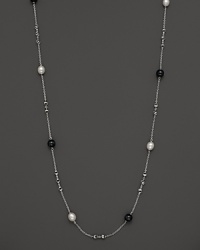 This sterling silver necklace, gleaming with blue tigers eye and freshwater pearls, makes an elegant statement. By Di MODOLO. This sterling silver necklace, gleaming with blue tigers eye and freshwater pearls, makes an elegant statement. By Di MODOLO.