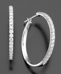 Bring on the glamour. These dazzling hoop earrings feature round-cut diamond (1-1/2 ct. t.w.) set in 14k white gold. Approximate diameter: 1 inch. Bring on the glamour. These dazzling hoop earrings feature round-cut diamond (1-1/2 ct. t.w.) set in 14k white gold. Approximate diameter: 1 inch.