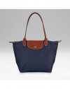 Pliage nylon signature tote, great for travel as well as everyday use. Top zip plus leather top handle, shoulder drop, 7½ Snap flap Inside pocket Folds up and snaps closed Opens to 9¾W X 9¾H x 5½D Imported
