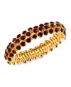 An elegant finishing touch from Anne Klein. Glass and plastic stones in red hues lend a look of romance to this bracelet. Crafted in gold tone mixed metal. Approximate diameter: 3 inches. Stretches to fit wrist.
