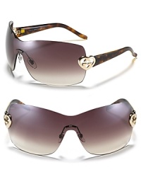 Fall in love with these shield sunglasses featuring a metal heart logo embellishment at temples. Fall in love with these shield sunglasses featuring a metal heart logo embellishment at temples.