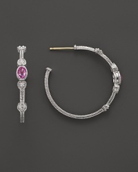 Faceted, oval-shaped pink corundum bring glamour to detailed sterling silver hoop earrings. Faceted, oval-shaped pink corundum bring glamour to detailed sterling silver hoop earrings.