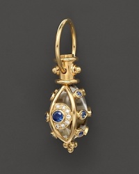 An 18K yellow gold evil eye amulet, set with diamonds and sapphires, frames a crystal. By Temple St. Clair. An 18K yellow gold evil eye amulet, set with diamonds and sapphires, frames a crystal. By Temple St. Clair.