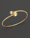 Bold, textured beads anchor this 18K yellow gold bangle. From the Marco Bicego Africa Collection.