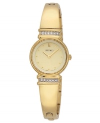 Time to dazzle: Crystals add sparkle to this bangle-style Seiko watch. Round goldtone mixed metal case and bracelet. Top and bottom of case crystallized with Swarovski elements. Champagne dial features logo, goldtone hands and crystal elements by Swarovski at indices. Quartz movement. Water resistant to 30 meters. Three-year limited warranty.