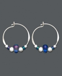 Petite hoops with a lot of character. These sterling silver hoops by Jody Coyote feature silver accents beads and light blue Czech glass beads. Approximate size: 5/8 inch x 3/4 inch. Petite hoops with a lot of character. These sterling silver hoops by Jody Coyote feature silver accents beads and light blue Czech glass beads. Approximate size: 5/8 inch x 3/4 inch.