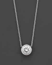 White gold bezel-set diamond solitaire necklace. With signature ruby accent. Designed by Roberto Coin. White gold bezel-set diamond solitaire necklace. With signature ruby accent. Designed by Roberto Coin.