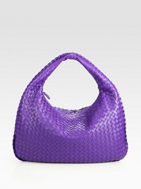 This woven leather design is accented with a plaited leather trim.Top handle, 5 dropTop zip closureOne inside zip pocketSuede lining16½W X 10½H X 2½DMade in Italy This woven leather design is accented with a plaited leather trim.Top handle, 5 dropTop zip closureOne inside zip pocketSuede lining16½W X 10½H X 2½DMade in Italy