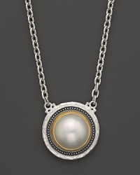 A cultured freshwater pearl is framed in a sterling silver & 24K gold setting with an ornate, organic feel. From Gurhan. A cultured freshwater pearl is framed in a sterling silver & 24K gold setting with an ornate, organic feel. From Gurhan.