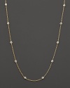 Diamond stations punctuate a long, elegant 18K yellow gold chain. By Roberto Coin.