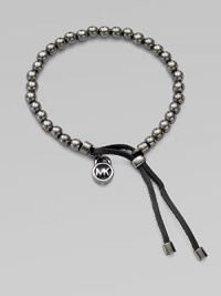 A smooth, beaded design with a logo lock charm and an adjustable leather closure. Gunmetal-finished metalDiameter, about 2.5Slip-on style with adjustable leather closureImported A smooth, beaded design with a logo lock charm and an adjustable leather closure. Gunmetal-finished metalDiameter, about 2.5Slip-on style with adjustable leather closureImported