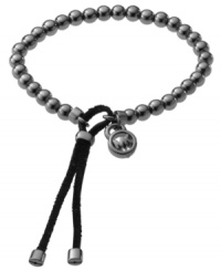Polished beads add glamour and edge. Michael Kors' trendy wrap bracelet features hematite tone beads with a black leather closure and MK logo charm. Bracelet stretches to fit wrist. Approximate diameter: 2-1/2 inches. Polished beads add glamour and edge. Michael Kors' trendy wrap bracelet features hematite tone beads with a black leather closure and MK logo charm. Bracelet stretches to fit wrist. Approximate diameter: 2-1/2 inches.