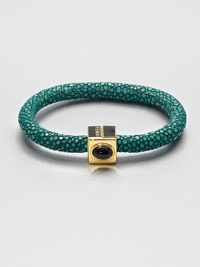 An exotic and luxurious design that features a stingray leather covered bangle accented with a colorful stone set in a logo accented closure. Available in grey stingyray with coral stone, green stingray with onyx stone, or blue stingray with jasper stone.Stingray leatherLength, about 7.5Magnetic closureMade in Italy An exotic and luxurious design that features a stingray leather covered bangle accented with a colorful stone set in a logo accented closure. Available in grey stingyray with coral stone, green stingray with onyx stone, or blue stingray with jasper stone.Stingray leatherLength, about 7.5Magnetic closureMade in Italy