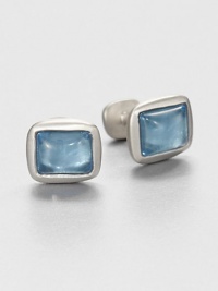 Handsome cabochon cushion cuff links set in sterling silver, highlighted by simulated blue topaz at the center.Sterling silverBlue topazAbout .59 x .67Made in USA Handsome cabochon cushion cuff links set in sterling silver, highlighted by simulated blue topaz at the center.Sterling silverBlue topazAbout .59 x .67Made in USA