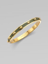 Richly dimensional skulls, gleaming and slightly ghoulish, line up around a graceful golden bangle layered in colorful enamel.EnamelGoldtoneDiameter, about 2½Imported Richly dimensional skulls, gleaming and slightly ghoulish, line up around a graceful golden bangle layered in colorful enamel.EnamelGoldtoneDiameter, about 2½Imported