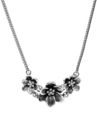 In full bloom. This cute frontal necklace from Fossil features a cluster of three floral pendants embellished with clear crystal stones. Crafted in silver tone mixed metal. Lobster claw closure. Approximate length: 18 inches. In full bloom. This cute frontal necklace from Fossil features a cluster of three floral pendants embellished with clear crystal stones. Crafted in silver tone mixed metal. Lobster claw closure. Approximate length: 18 inches.