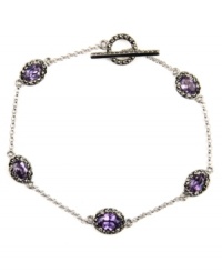 Glittering and glamorous. A delicate link silhouette defines this exquisite bracelet from Judith Jack. Embellished with sparkling marcasite and purple synthetic corundum (3-1/10 ct. t.w.), it's set in sterling silver and includes a toggle closure. Approximate length: 7-1/4 inches. Glittering and glamorous. A delicate link silhouette defines this exquisite bracelet from Judith Jack. Embellished with sparkling marcasite and purple synthetic corundum (3-1/10 ct. t.w.), it's set in sterling silver and includes a toggle closure. Approximate length: 7-1/4 inches.