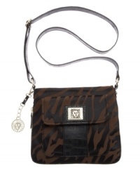 A trio of key features make the Trinity from AK Anne Klein your next go-to purse: a front flap pocket, the trendy pebbled texture and the adjustable crossbody strap. A trio of key features make the Trinity from AK Anne Klein your next go-to purse: a front flap pocket, the trendy pebbled texture and the adjustable crossbody strap.