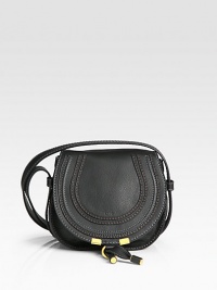 Rich leather defines this rounded crossbody silhouette, finished with tonal strips for textured appeal.Crossbody strap, 21 drop Flap with buckle closure One outside open pocket under flap One cell phone pocket Cotton lining 7W X 6½H X 3¾D Made in Spain Rich leather defines this rounded crossbody silhouette, finished with tonal strips for textured appeal.Crossbody strap, 21 drop Flap with buckle closure One outside open pocket under flap One cell phone pocket Cotton lining 7W X 6½H X 3¾D Made in Spain