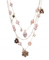 The perfect combination of pink and crystal - fit for a princess. This three-tier illusion necklace by Betsey Johnson features delicate strands decorated with pink crystals and charms. Crafted in gold tone mixed metal. Approximate length: 16 inches + 3-inch extender. Approximate drop: 3/4 inch.