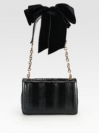 A theatrical style in luxurious python with smooth leather trim and a dramatic velvet shoulder bow.Chain, leather and velvet shoulder strap, 11¼ dropMagnetic snap flap closureThree inner compartmentsOne inside open pocketSignature red lining9¾W X 6H X 2½DMade in Italy A theatrical style in luxurious python with smooth leather trim and a dramatic velvet shoulder bow.Chain, leather and velvet shoulder strap, 11¼ dropMagnetic snap flap closureThree inner compartmentsOne inside open pocketSignature red lining9¾W X 6H X 2½DMade in Italy