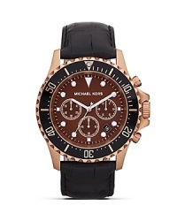 Classically styled accessories are on our radar. Perfect the look with this rose gold watch from MICHAEL Michael Kors, accented by a bold bezel and embossed leather strap. Classically styled accessories are on our radar. Perfect the look with this rose gold watch from MICHAEL Michael Kors, accented by a bold bezel and embossed leather strap.