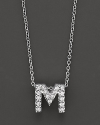From the Tiny Treasures collection, a diamond M necklace. With signature ruby accent. Designed by Roberto Coin. From the Tiny Treasures collection, a diamond M necklace. With signature ruby accent. Designed by Roberto Coin.