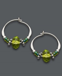 Traditional hoops with a springtime touch. Jody Coyote combines a petite sterling silver hoop setting with vibrant crystal beads in bright green hues. Approximate diameter: 5/8 inch. Traditional hoops with a springtime touch. Jody Coyote combines a petite sterling silver hoop setting with vibrant crystal beads in bright green hues. Approximate diameter: 5/8 inch.